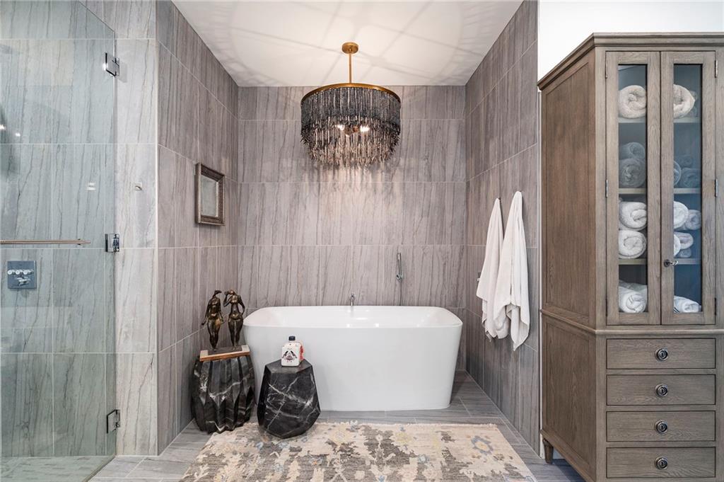 2520 Peachtree Road West, Unit 1203 Atlanta, GA 30305 - Photo 31 of 65 a bedroom with a bed and a chandelier