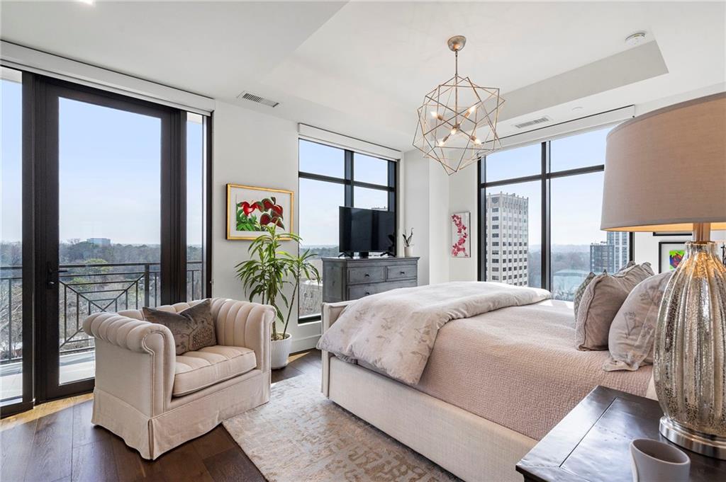 2520 Peachtree Road West, Unit 1203 Atlanta, GA 30305 - Photo 37 of 65 a bedroom with a large bed a flat screen tv and a chandelier