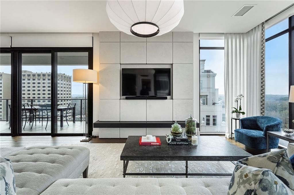 2520 Peachtree Road West, Unit 1203 Atlanta, GA 30305 - Photo 4 of 65 a living room with furniture a large window and a flat screen tv