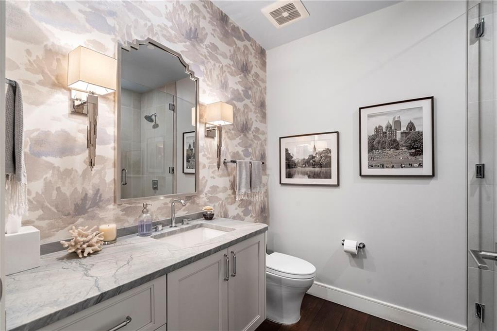 2520 Peachtree Road West, Unit 1203 Atlanta, GA 30305 - Photo 48 of 65 a bathroom with a granite countertop sink mirror and toilet