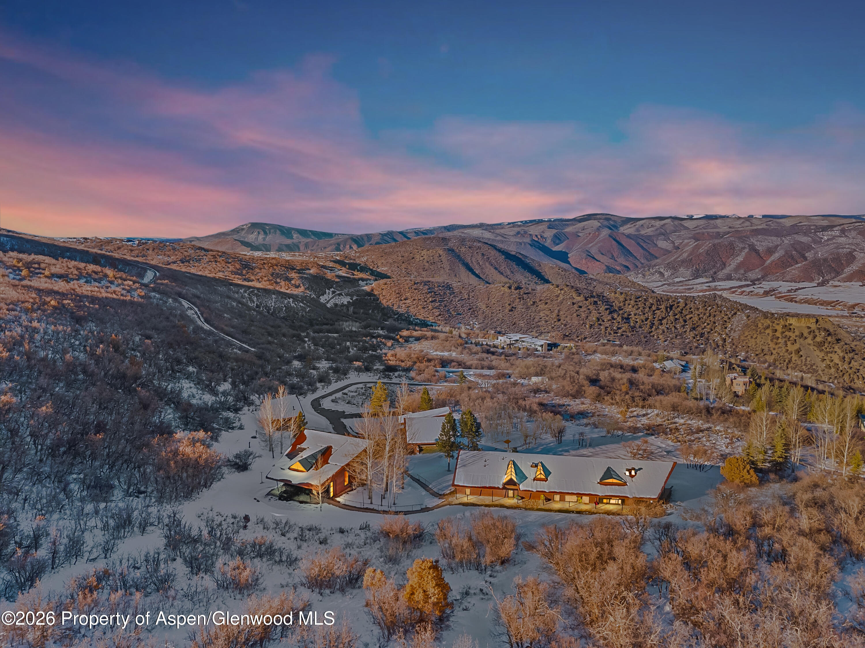 an aerial view of a house with a ocean view