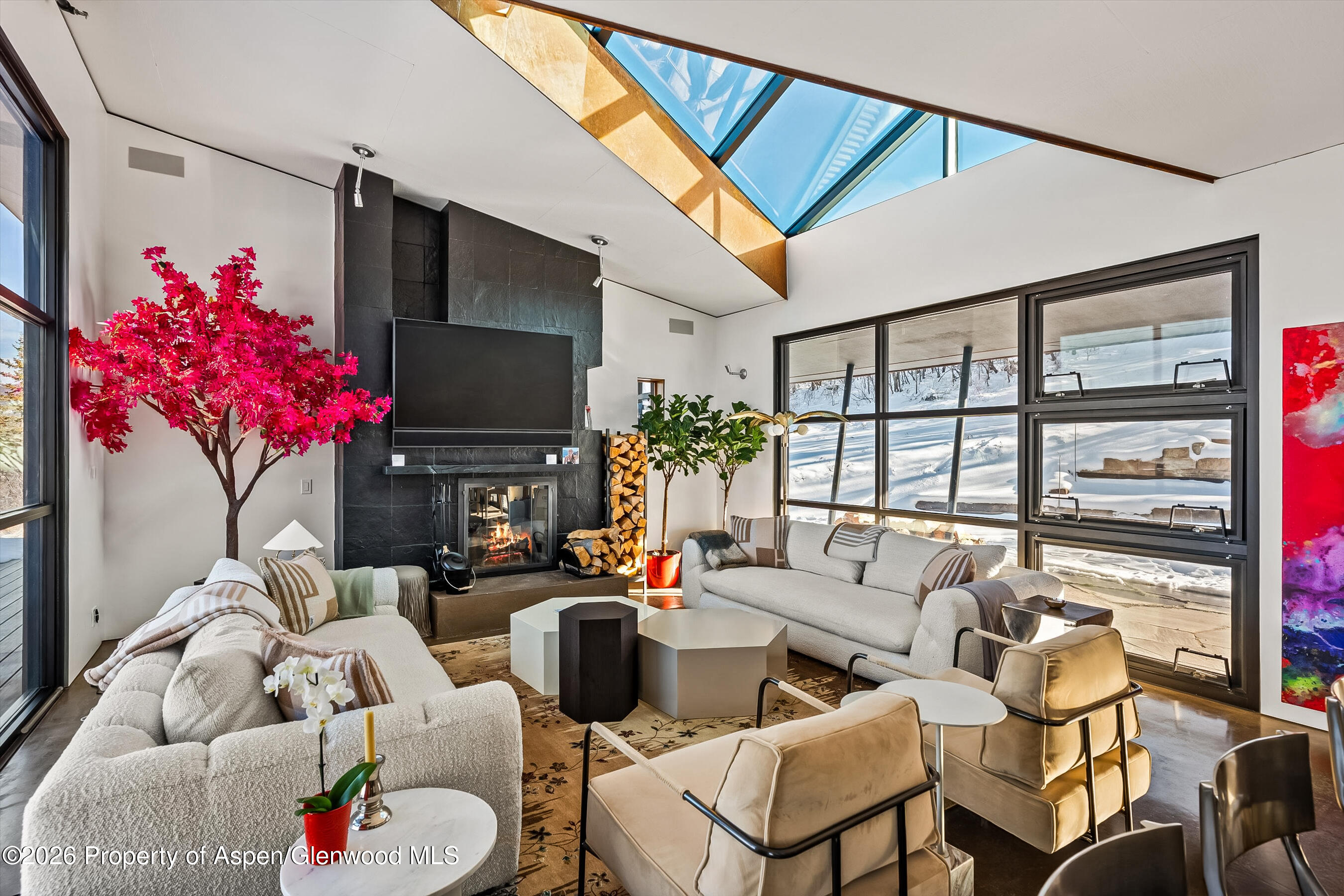 2700 Juniper Hill Road Aspen, CO 81611 - Photo 12 of 39 a living room with furniture a flat screen tv and a floor to ceiling window