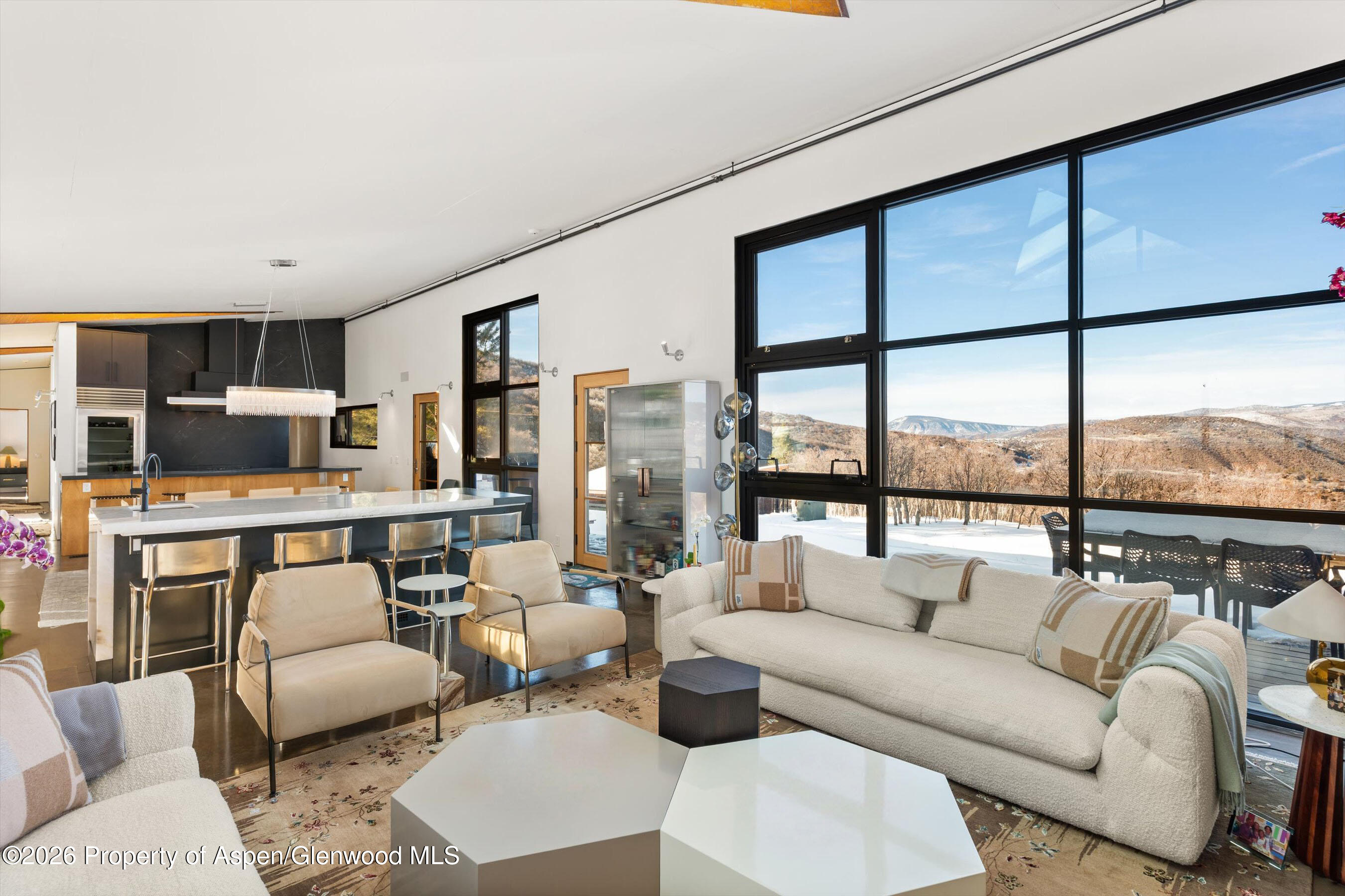 2700 Juniper Hill Road Aspen, CO 81611 - Photo 14 of 39 a living room with furniture kitchen view and large windows