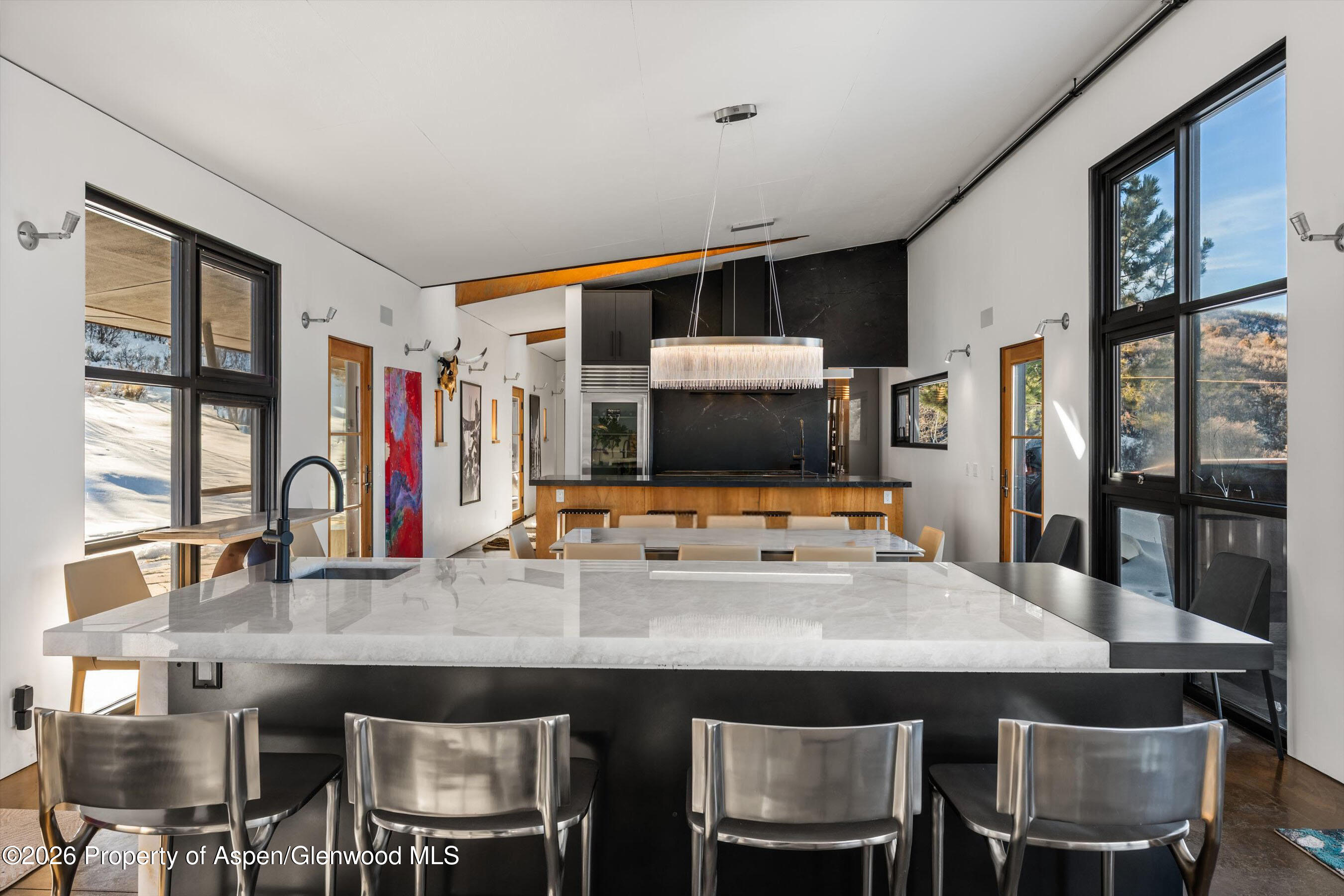2700 Juniper Hill Road Aspen, CO 81611 - Photo 17 of 39 a kitchen with stainless steel appliances a dining table and chairs