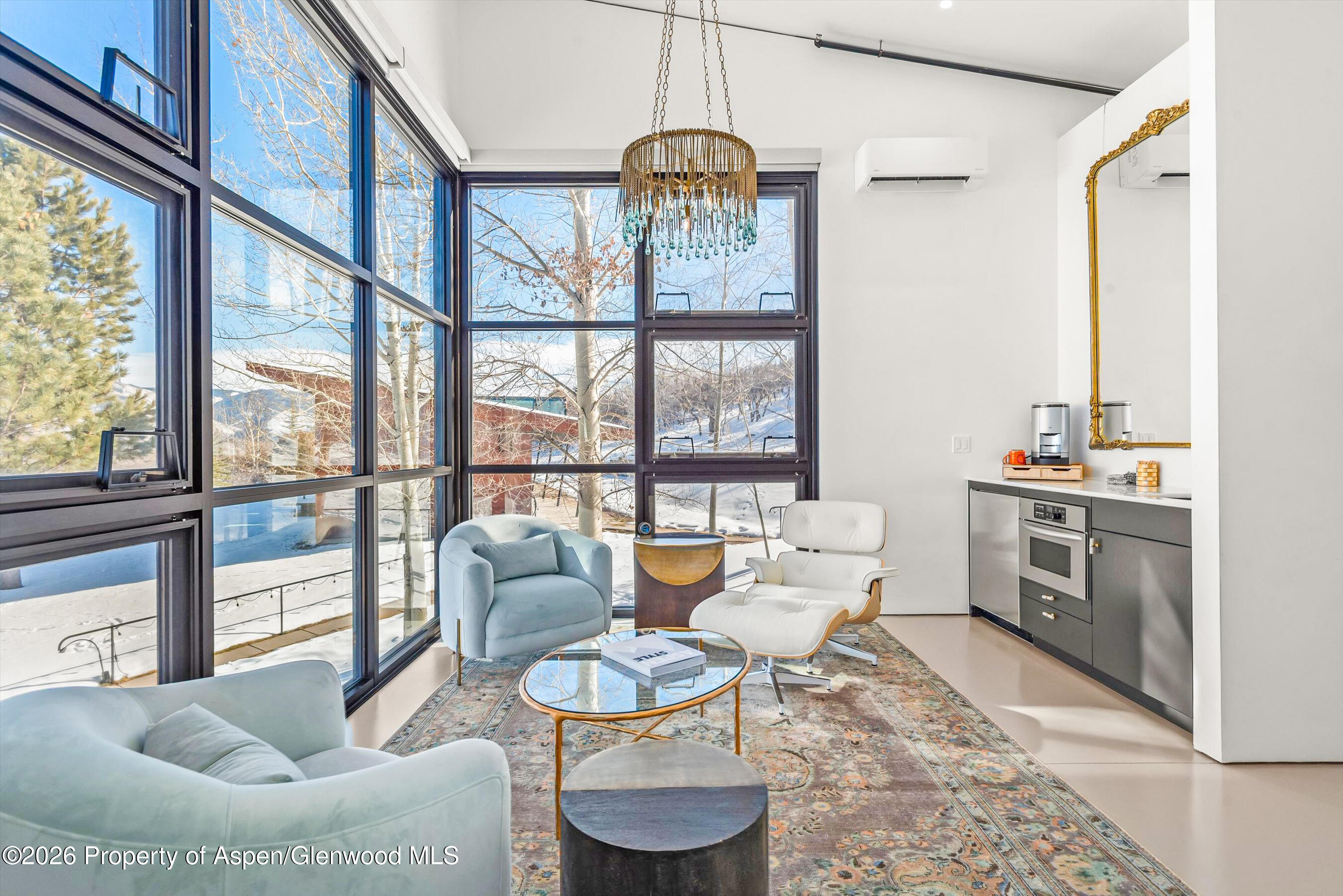 2700 Juniper Hill Road Aspen, CO 81611 - Photo 20 of 39 a dining room with furniture a chandelier and wooden floor