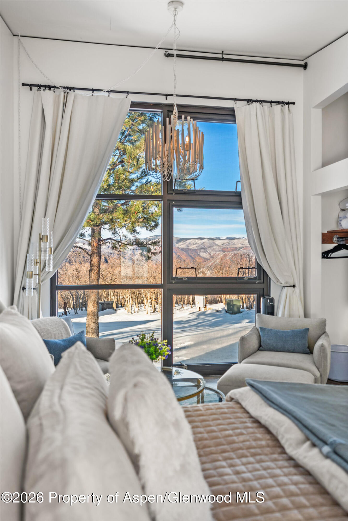 2700 Juniper Hill Road Aspen, CO 81611 - Photo 26 of 39 a living room with large windows and a table