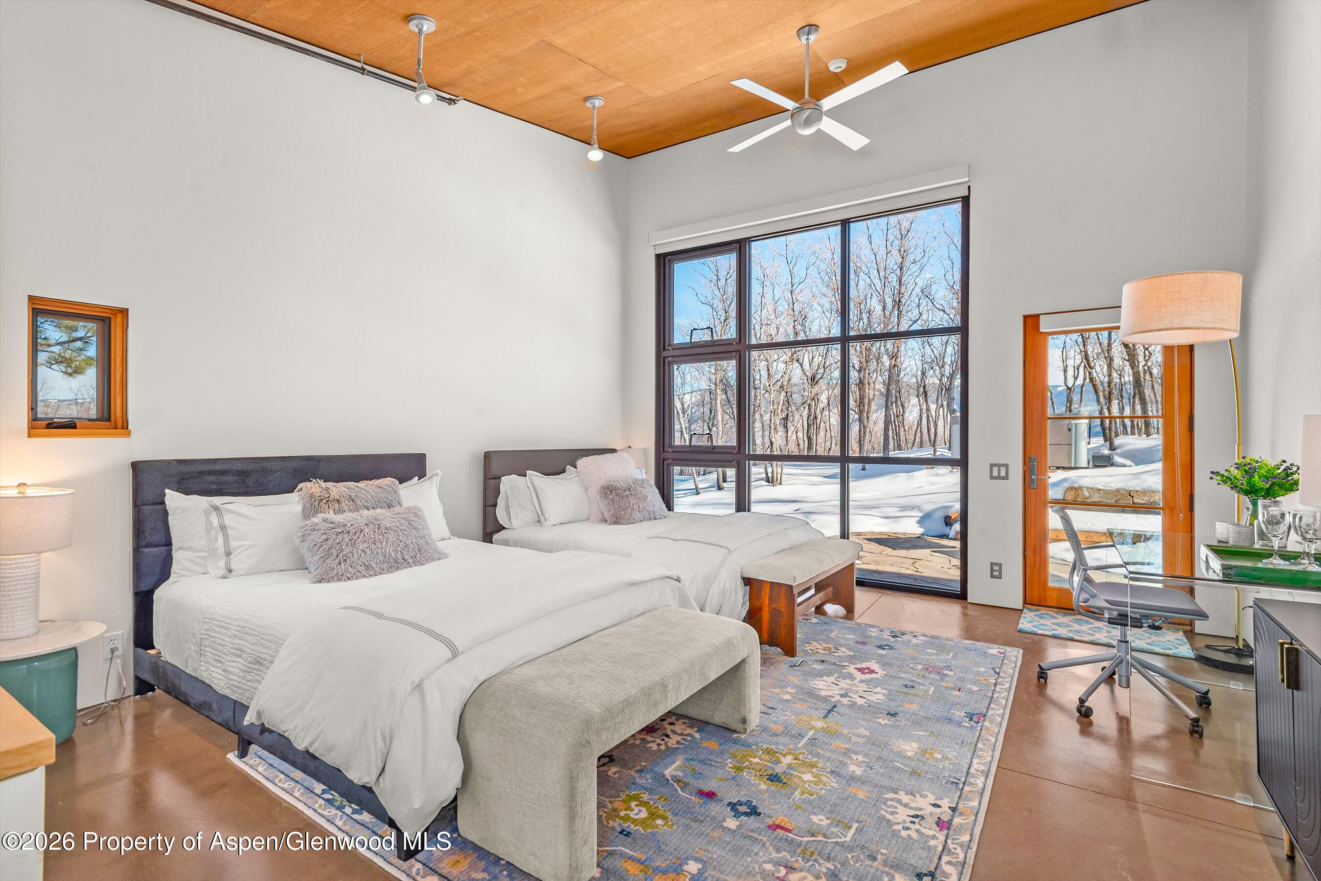 2700 Juniper Hill Road Aspen, CO 81611 - Photo 28 of 39 a bedroom with a large bed and a large window