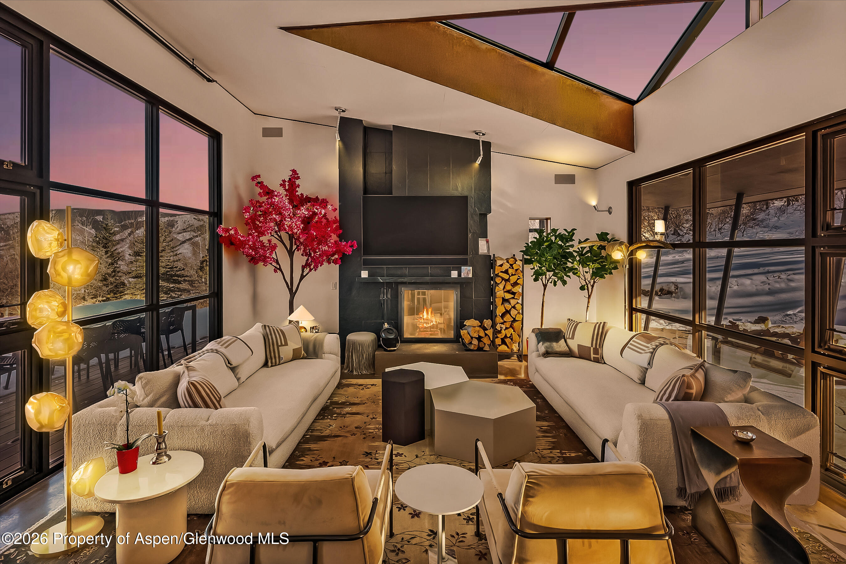 2700 Juniper Hill Road Aspen, CO 81611 - Photo 4 of 39 a living room with furniture a flat screen tv and a floor to ceiling window