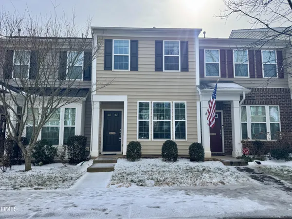 a front view of a building with trees