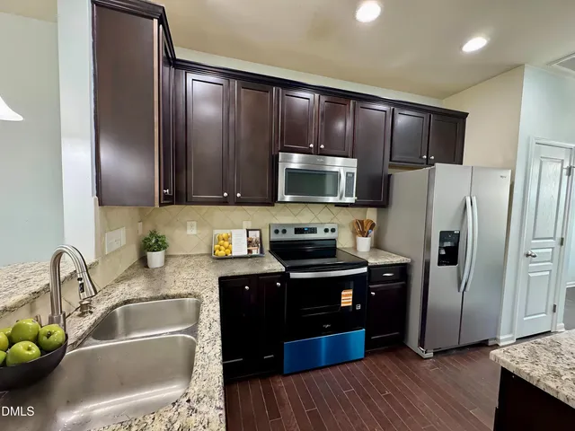 a bathroom with a granite countertop sink and mirror