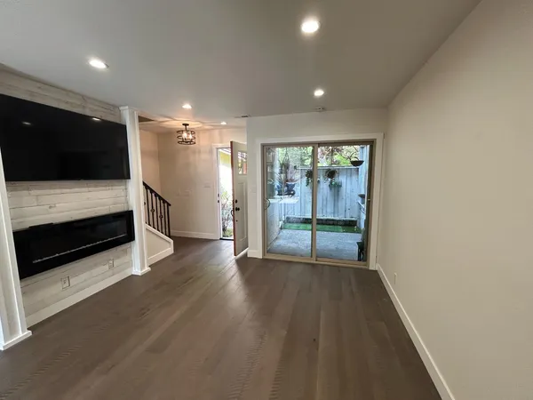 a view of hallway with stairs and wooden floor