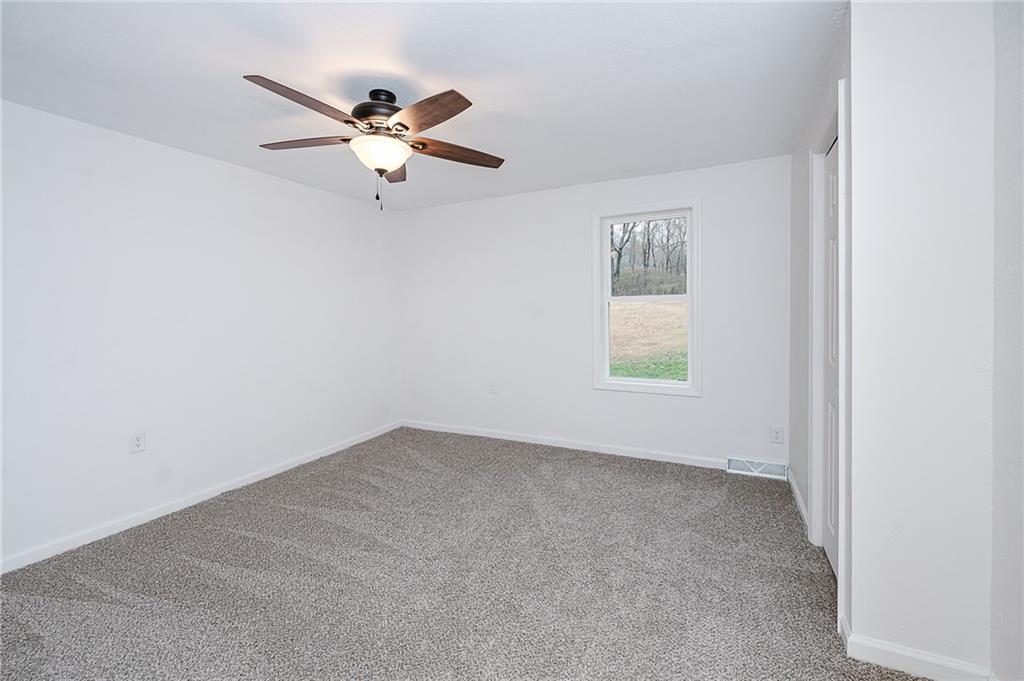 733 Metz Road Indiana, PA 15701 - Photo 21 of 42 an empty room with a window and a ceiling fan