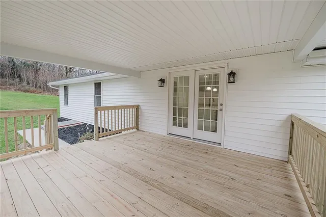 a view of backyard with a deck and wooden floor