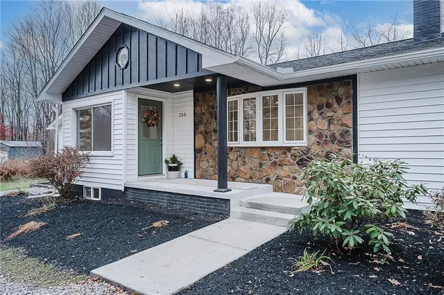 a front view of a house with garden