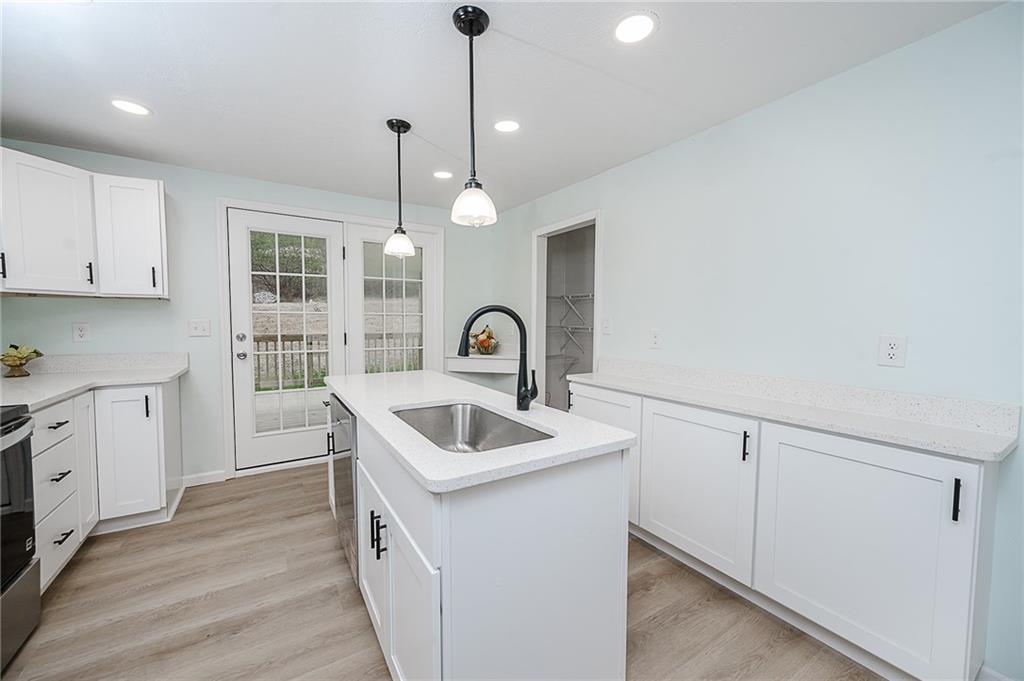 733 Metz Road Indiana, PA 15701 - Photo 5 of 42 a kitchen that has a sink a stove and dishwasher with wooden floor