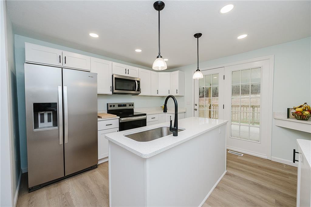 733 Metz Road Indiana, PA 15701 - Photo 6 of 42 a kitchen with stainless steel appliances granite countertop a refrigerator a sink a stove and a wooden floors