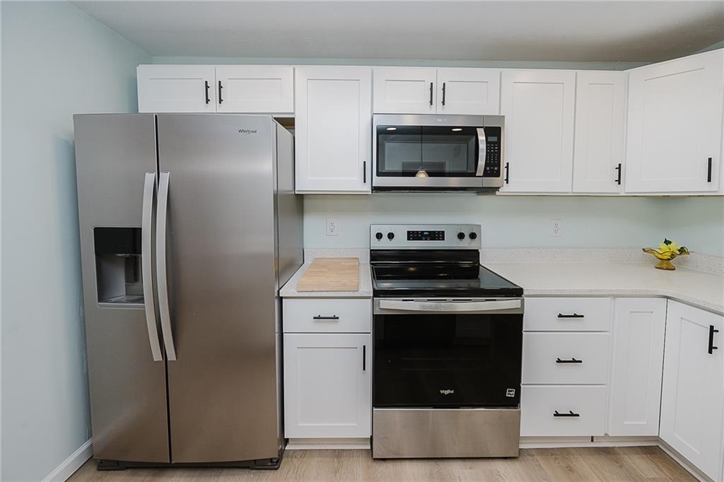 733 Metz Road Indiana, PA 15701 - Photo 7 of 42 a kitchen with stainless steel appliances a refrigerator stove and white cabinets