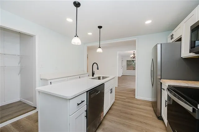 a kitchen with a sink and stainless steel appliances
