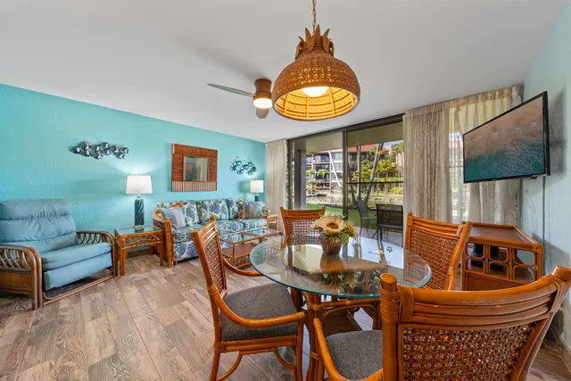 a kitchen with stainless steel appliances granite countertop a stove and chairs
