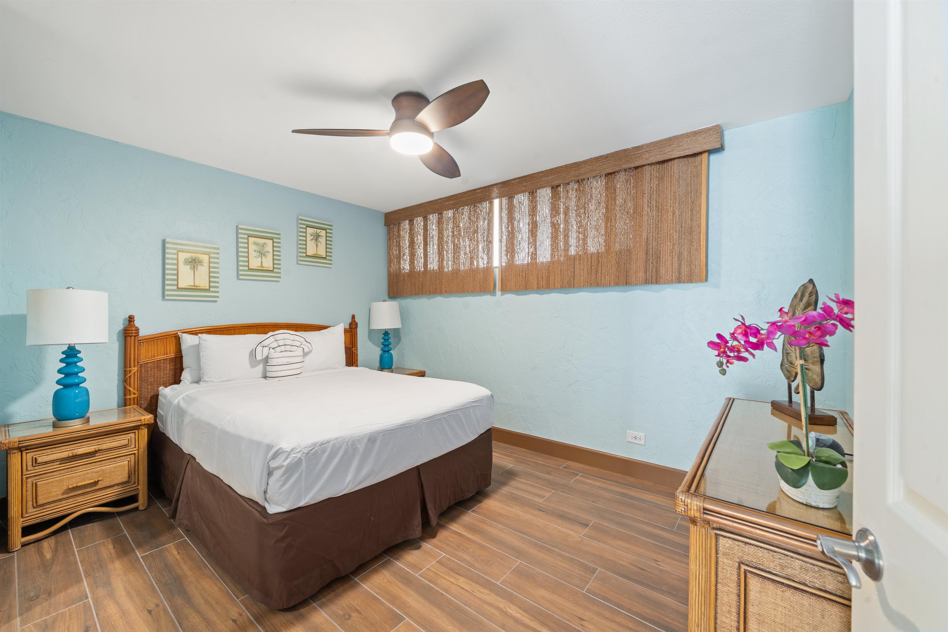 3543 Lower Honoapiilani Road, Unit G103 Lahaina, HI 96761 - Photo 22 of 47 a bedroom with bed and wooden floor