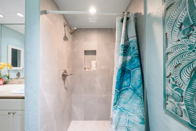 a bathroom with a sink vanity tub and shower