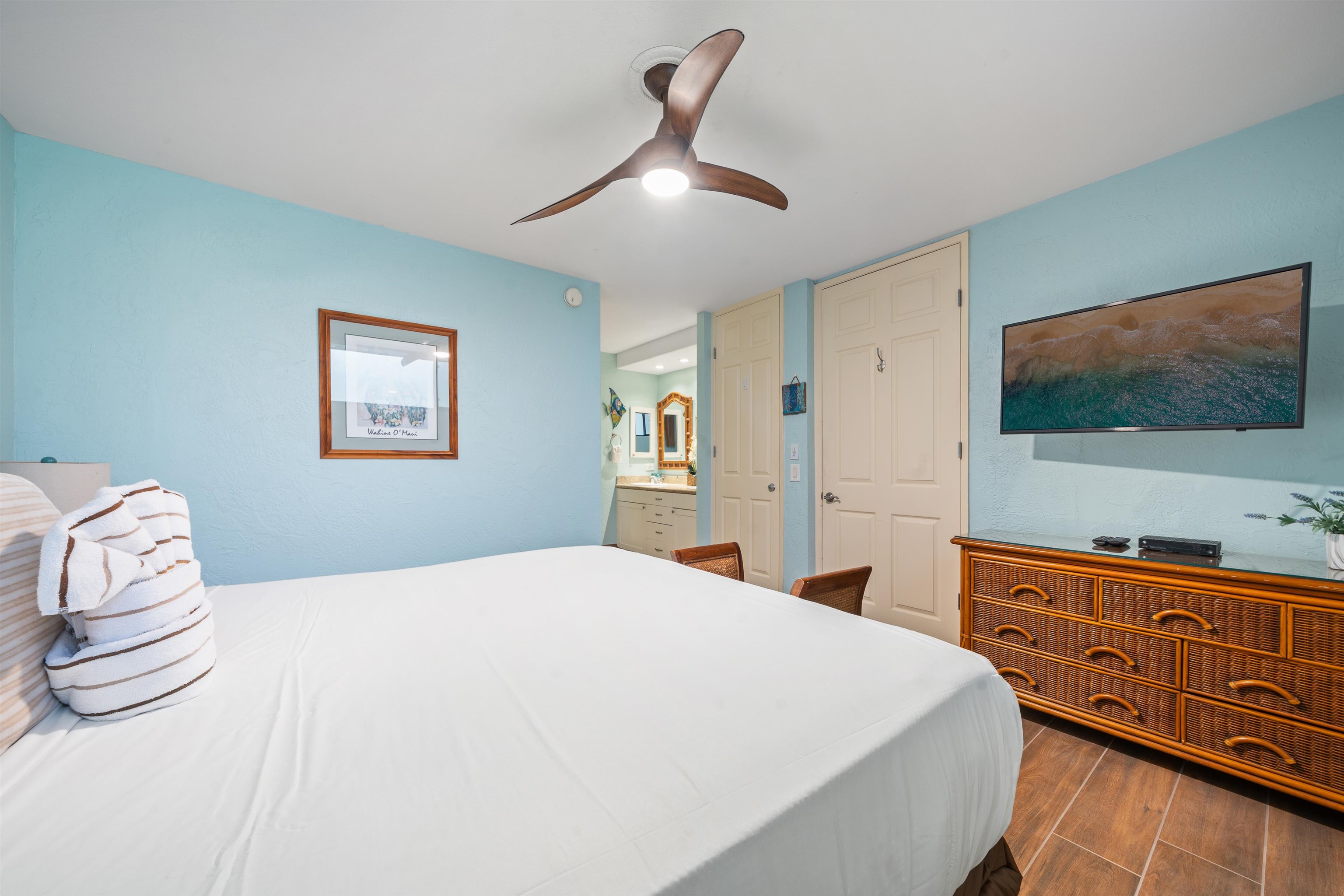 3543 Lower Honoapiilani Road, Unit G103 Lahaina, HI 96761 - Photo 28 of 47 a bedroom with a bed and a flat screen tv in it