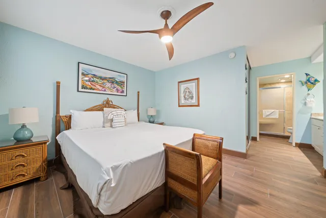 a spacious bathroom with a granite countertop sink mirror and a bathtub
