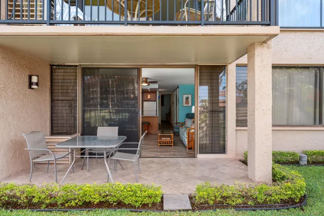 a view of a chairs and table in backyard
