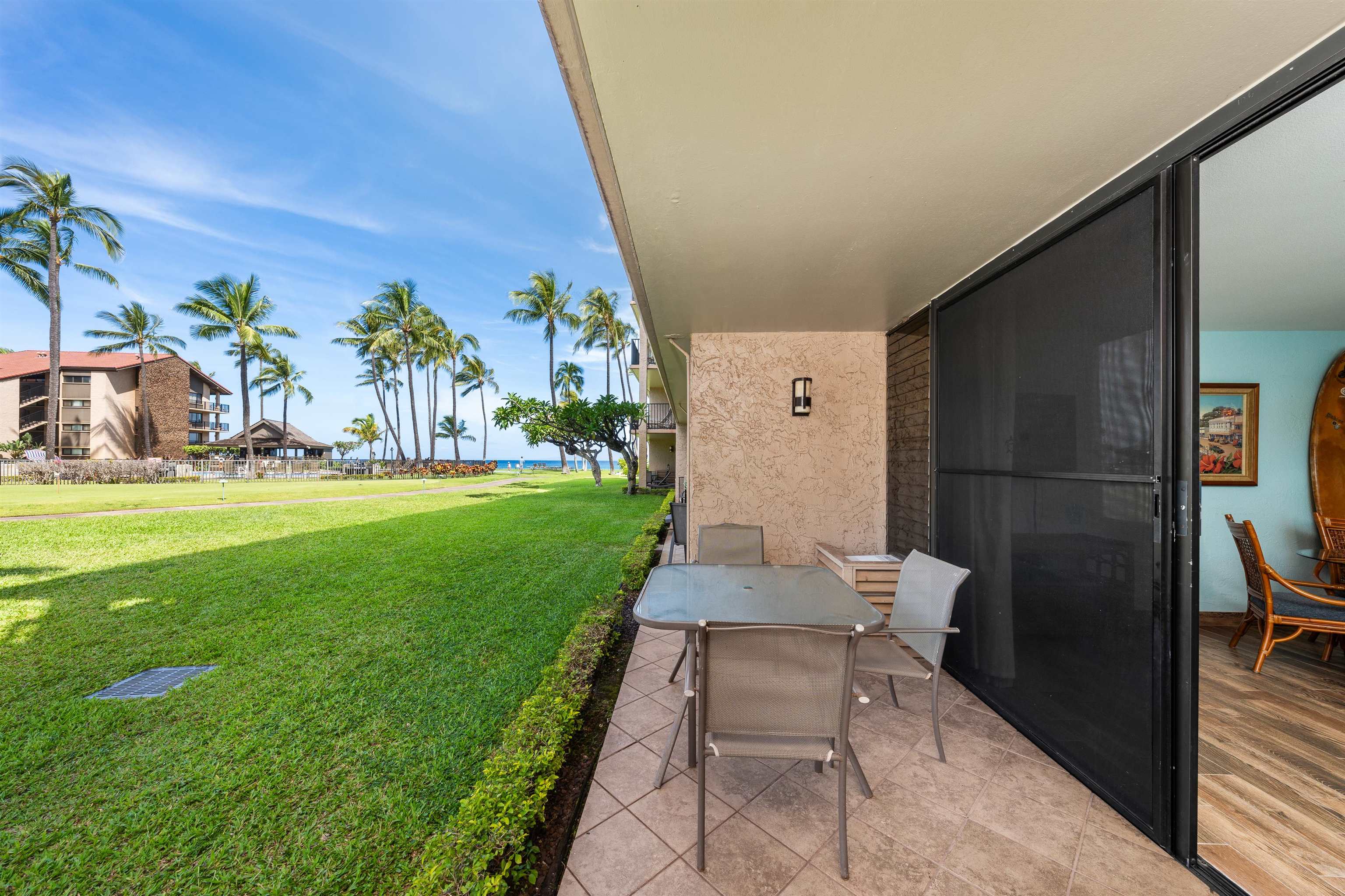 3543 Lower Honoapiilani Road, Unit G103 Lahaina, HI 96761 - Photo 7 of 47 a backyard of a house with table and chairs