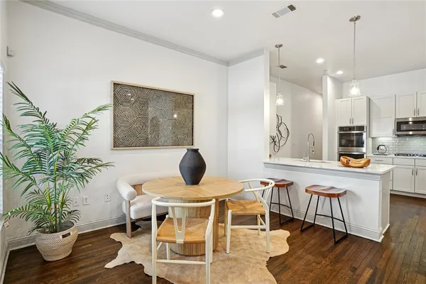 a dining room with furniture and wooden floor