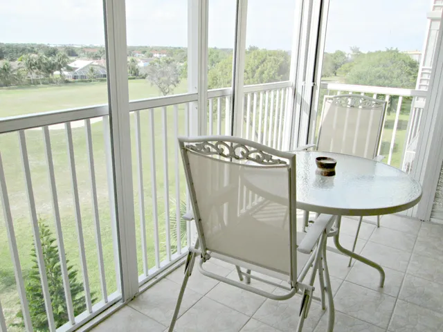 a view of a balcony with chair and white floor