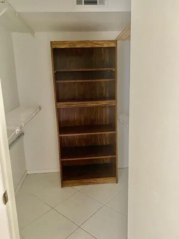 a view of storage and utility room with a door