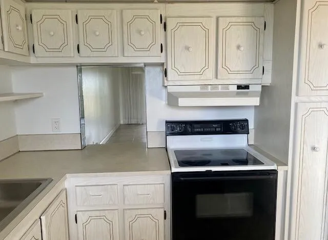 a stove top oven sitting inside of a kitchen