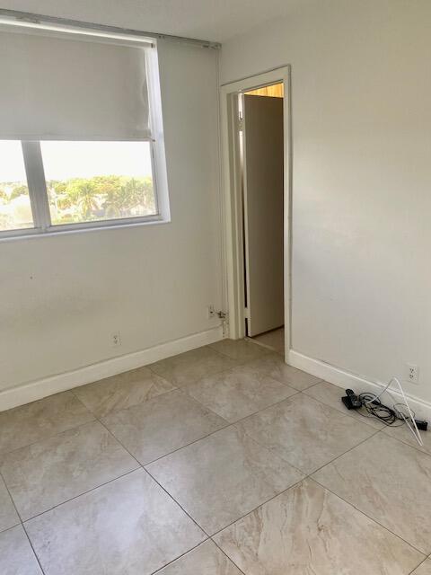 6161 Northwest 2nd Avenue, Unit FOUR Boca Raton, FL 33487 - Photo 30 of 50 an empty room with a window