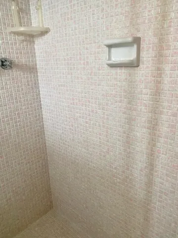 a bathroom with a glass shower door