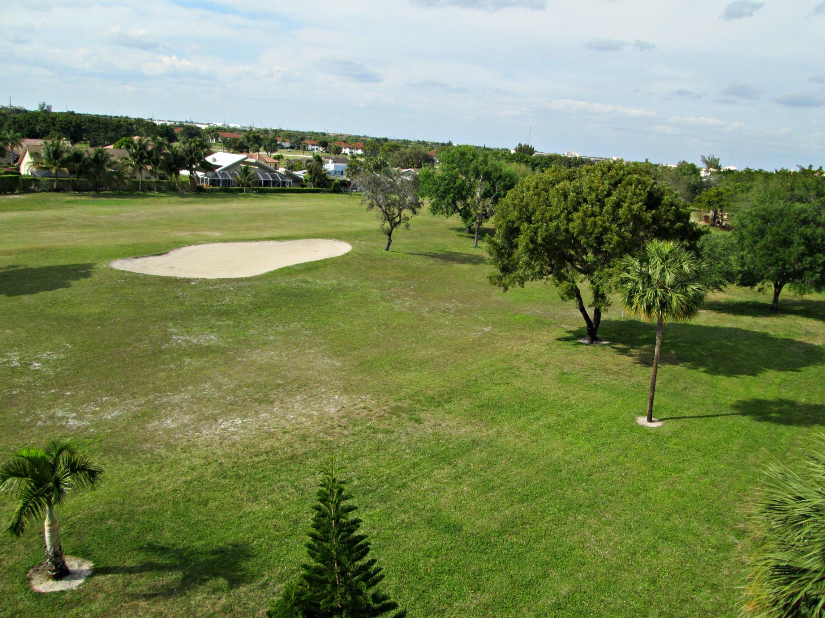 6161 Northwest 2nd Avenue, Unit FOUR Boca Raton, FL 33487 - Photo 5 of 50 a view of a golf course with a lake