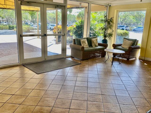 6161 Northwest 2nd Avenue, Unit FOUR Boca Raton, FL 33487 - Photo 8 of 50 a living room with patio furniture and floor to ceiling window