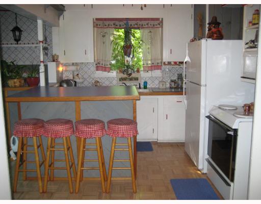 58 Rebekah Street Woonsocket, RI 02895 - Photo 5 of 8 Kitchen. Eat in Kitchen w/Island and new Appliances. Slider to rear deck the the left.