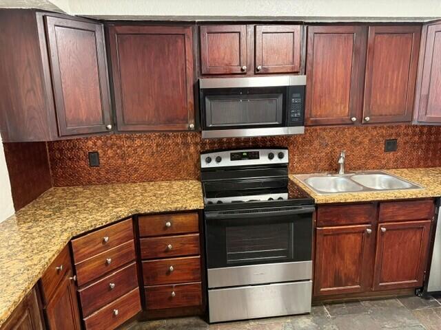 103 Northeast 28th Street Boca Raton, FL 33431 - Photo 12 of 47 a kitchen with granite countertop wooden cabinets and a stove top oven