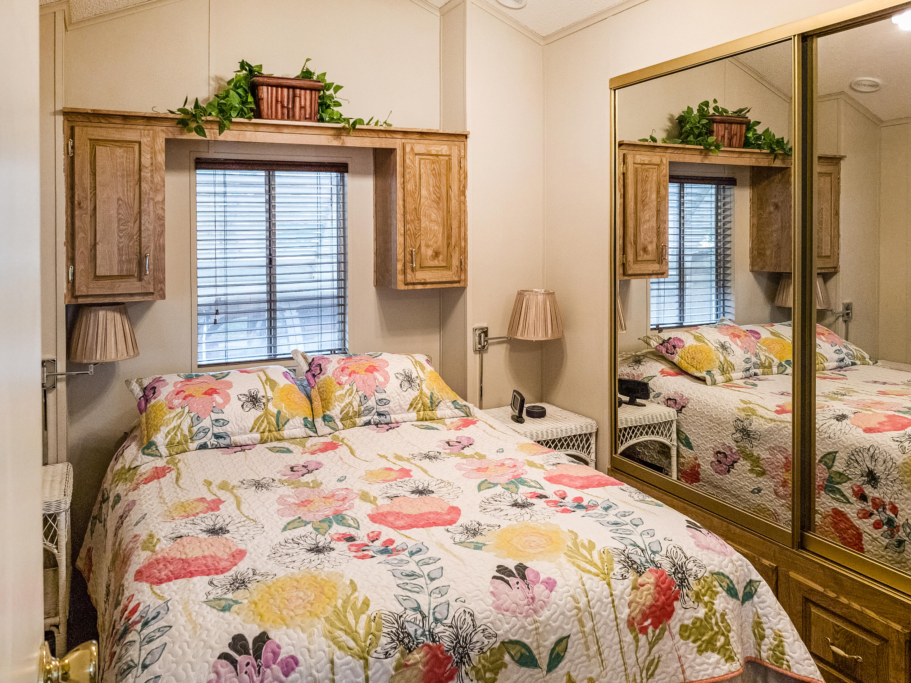 70200 Dillon Road, Unit 160 Desert Hot Springs, CA 92241 - Photo 12 of 31 a bedroom with a bed and wooden floor