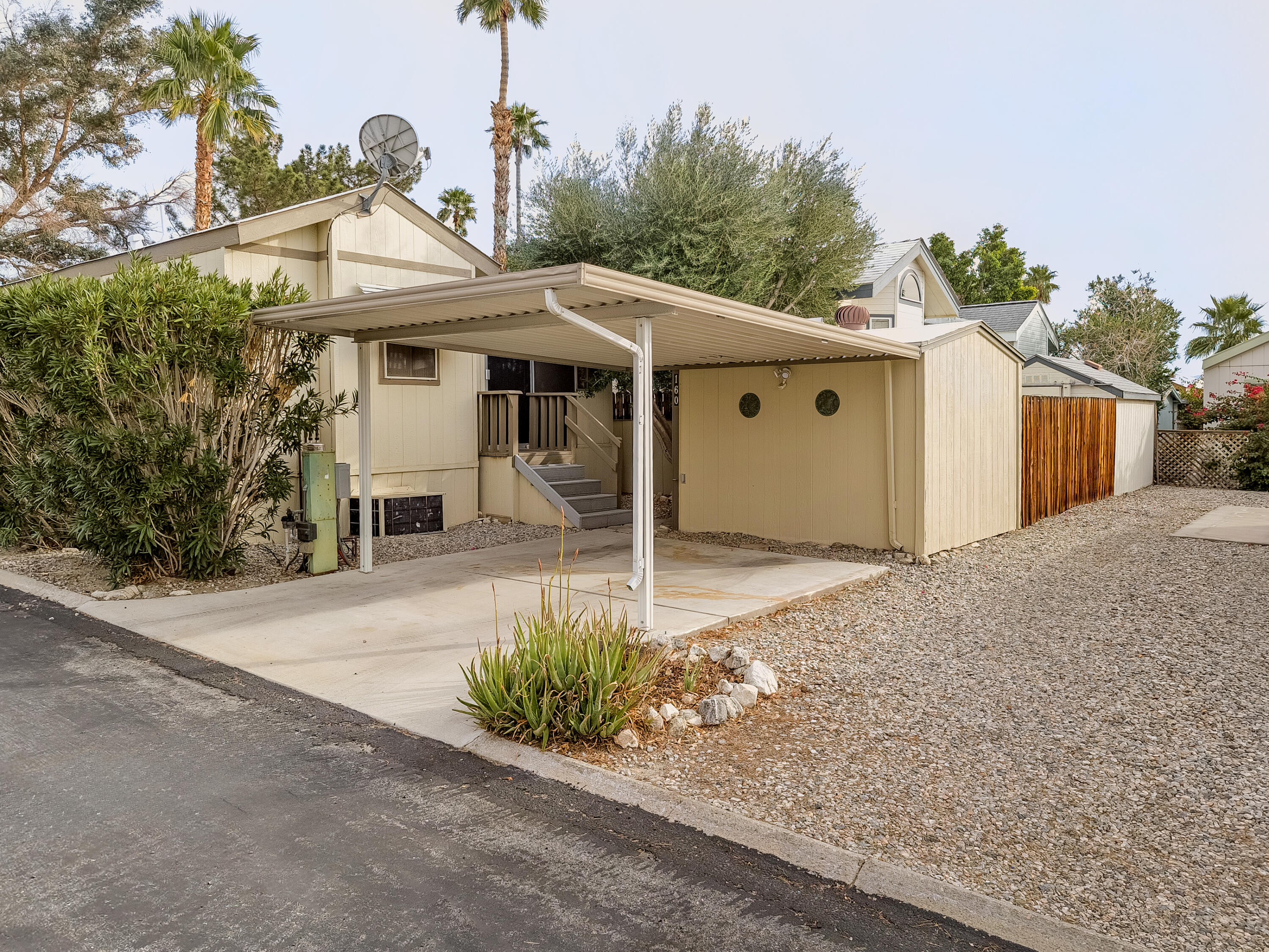 70200 Dillon Road, Unit 160 Desert Hot Springs, CA 92241 - Photo 2 of 31 a front view of a house with garden