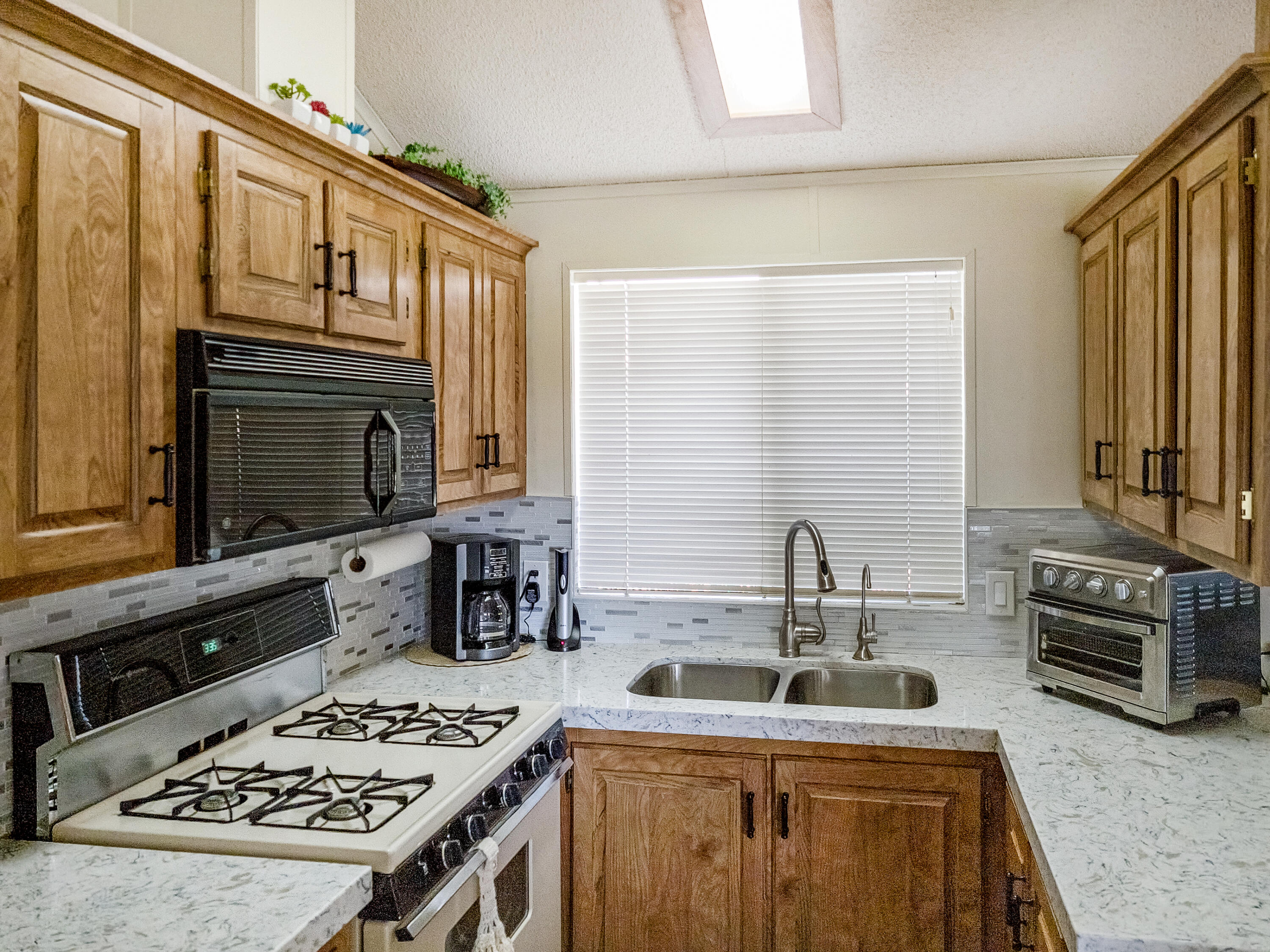 70200 Dillon Road, Unit 160 Desert Hot Springs, CA 92241 - Photo 7 of 31 a kitchen with a sink stove and cabinets