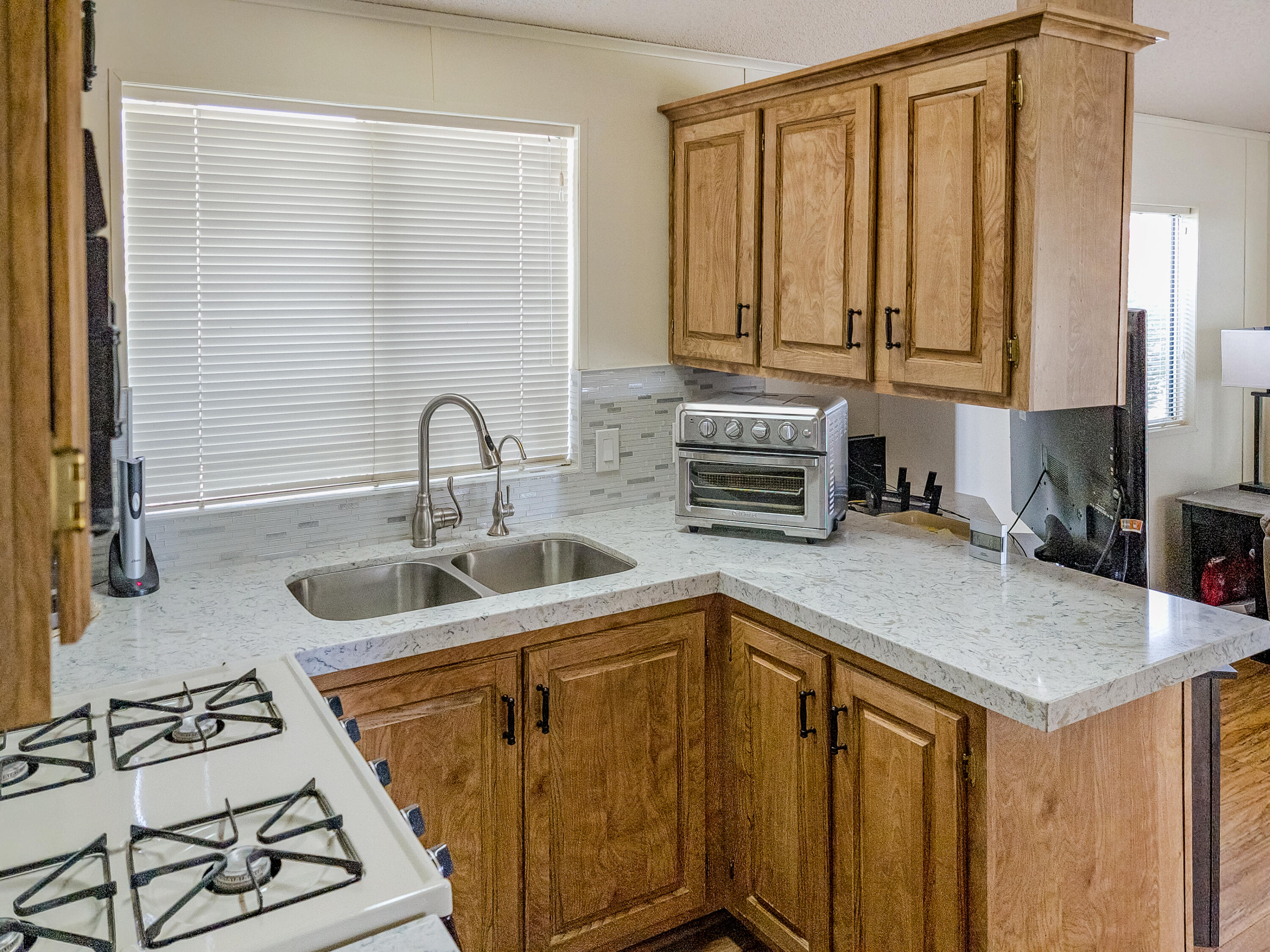 70200 Dillon Road, Unit 160 Desert Hot Springs, CA 92241 - Photo 9 of 31 a kitchen with stainless steel appliances granite countertop a sink stove and cabinets