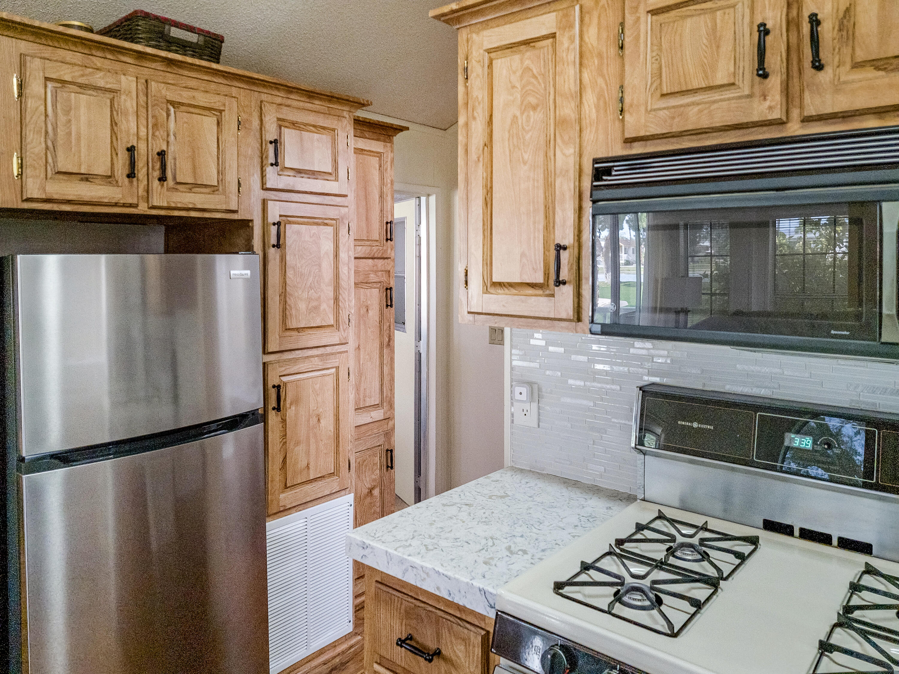 70200 Dillon Road, Unit 160 Desert Hot Springs, CA 92241 - Photo 10 of 31 a kitchen with stainless steel appliances granite countertop a refrigerator and a stove top oven