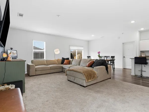 a living room with furniture and kitchen view