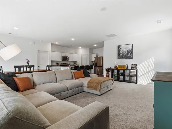 a living room with furniture and a large mirror