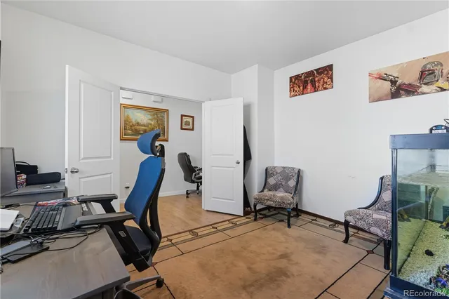 a view of a workspace with furniture and a window