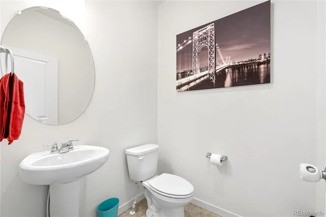 a bathroom with a sink mirror and toilet