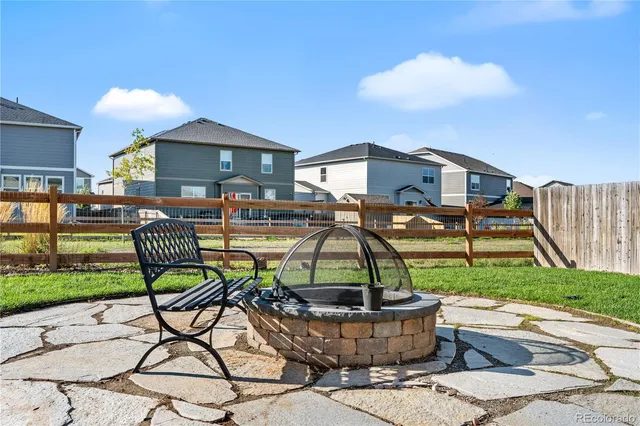 a front view of a house with a garden and patio