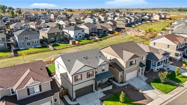 an aerial view of a house with swimming pool and outdoor seating